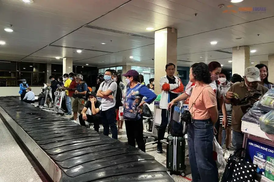 Passengers waiting at luggage carrousel
